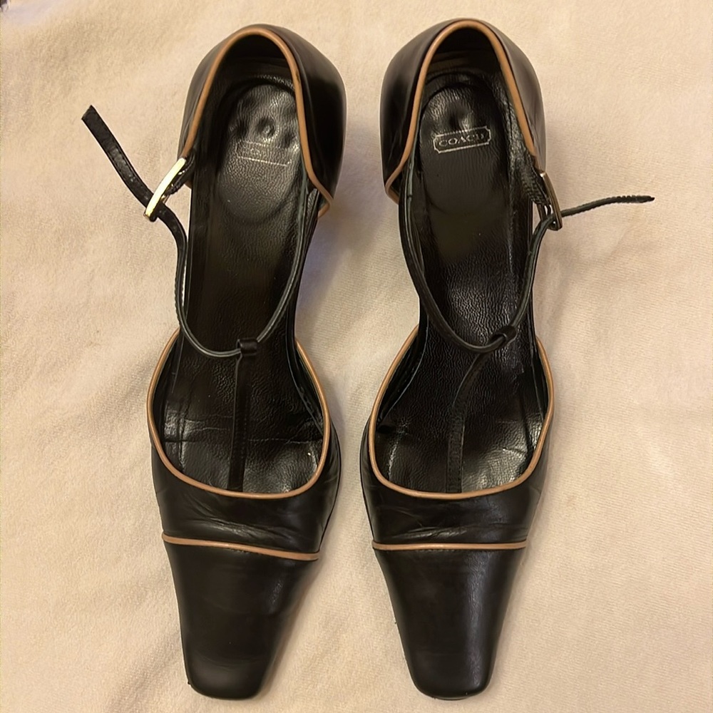 Coach Black leather T-strap square toe pumps with tan piping. Pre-owned.